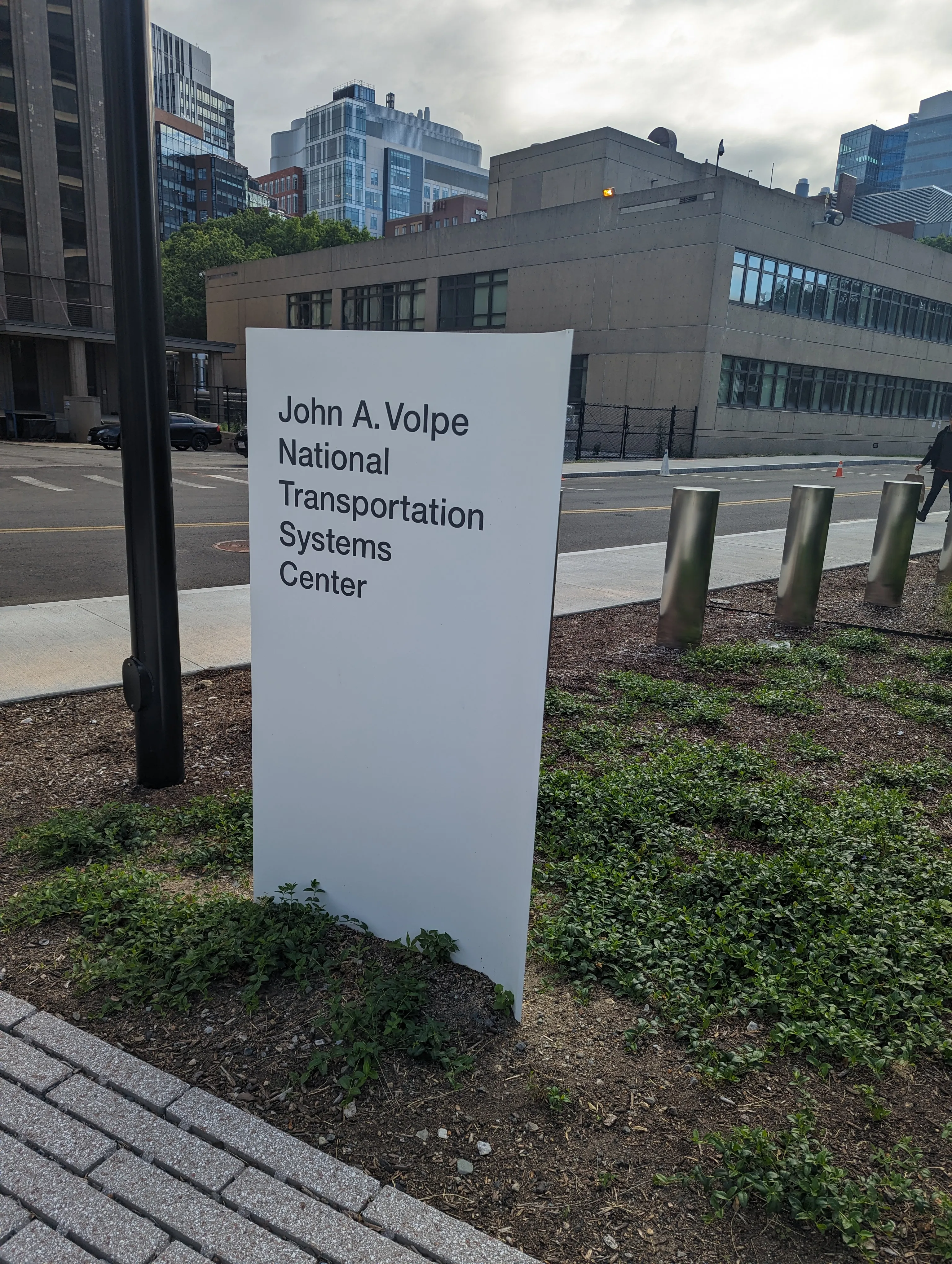 Sign in front of Volpe building, which reads 'John A. Volpe National Transportation Systems Center'.